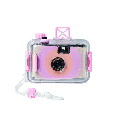 Introducing the Sunnylife Magenta Underwater Camera—a pink and purple retro-style waterproof film camera housed in a transparent waterproof case with a white wrist strap. This focus-free lens camera is shown from the front, set against a clean white background.