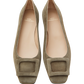 A pair of greenish-brown suede flats with square buckles and rounded toes, branded "Ann Mashburn" as the Suede Buckle Shoe.