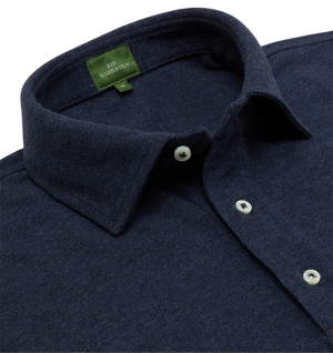 A close-up of a navy blue Sid Mashburn Long-Sleeve Polo shows a cut-and-sew collar, white buttons, and a green inner label with "SID MASHBURN.