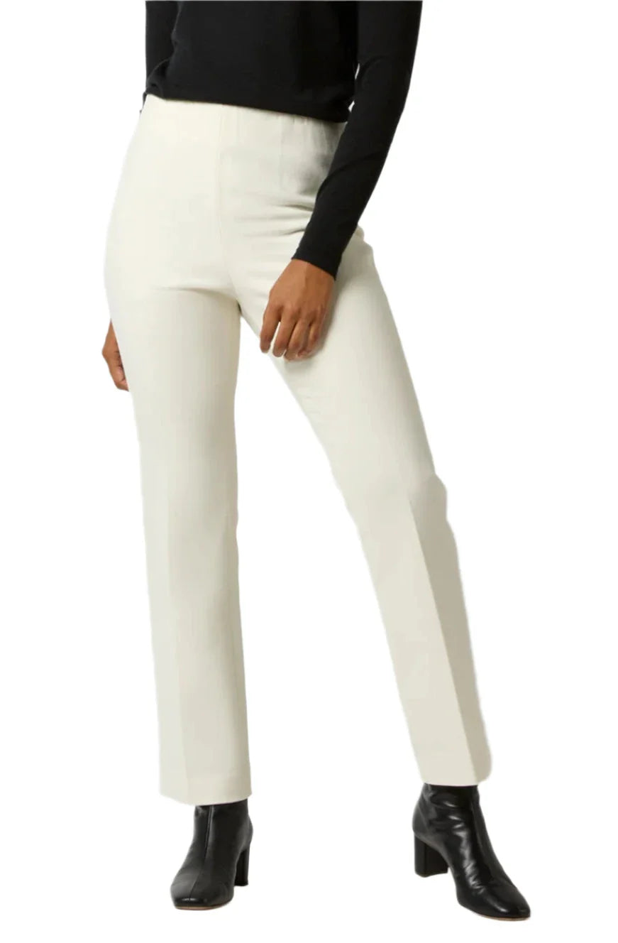 Person wearing Ann Mashburn Fayette Flare Cropped Bi-Stretch Pants, a black sweater, and black ankle boots, standing against a white background.