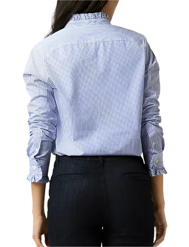 Rear view of a person wearing the Ann Mashburn Frill Shirt, an Italian poplin piece in blue and white stripes with rolled-up sleeves and a frilled placket, paired with dark jeans.