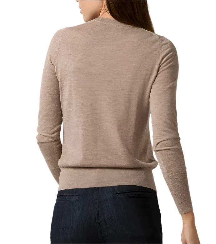 A person in dark jeans is wearing an Ann Mashburn Alida Crewneck Sweater in light brown and is facing away from the camera.