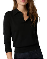 A person wearing an Ann Mashburn Alida Johnny-Collar Sweater, a long-sleeve black fine-gauge shirt, paired with dark jeans. The individual has long, wavy brown hair and their head is slightly cropped out of the image.