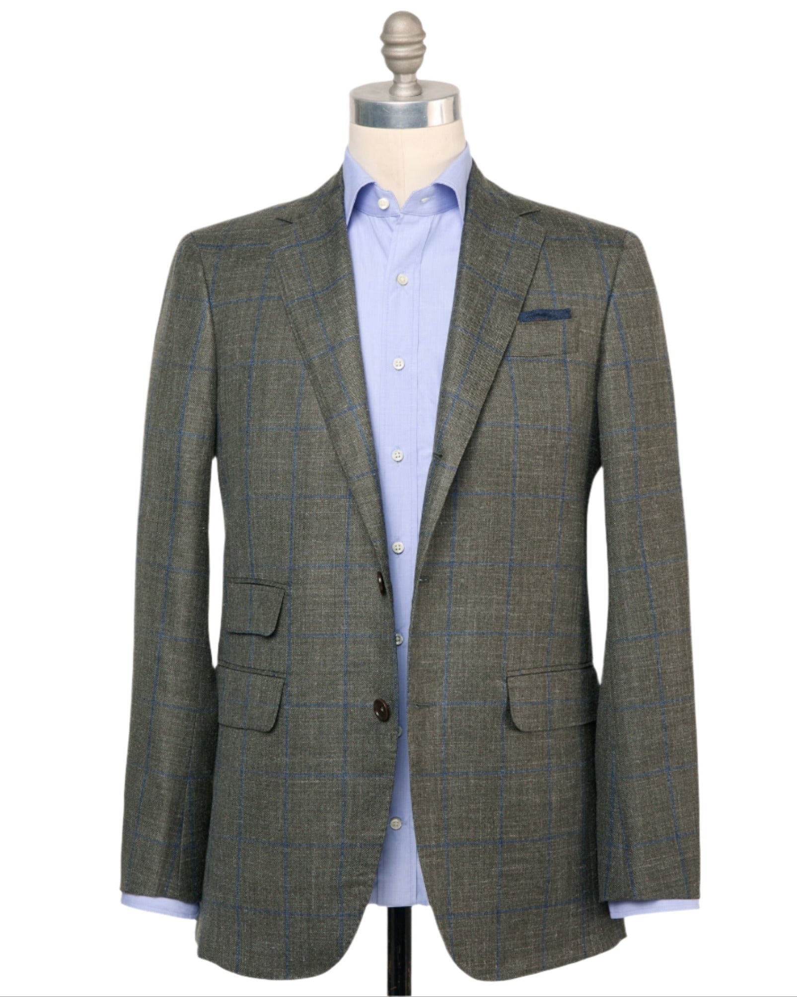 The Sid Mashburn Virgil No. 2 Jacket, in gray plaid with blue accents and a spalla camicia cut, is shown over a light blue dress shirt on a dress form against a white background.