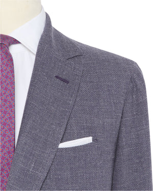 Close-up of a person wearing the Sid Mashburn Ghost Blazer, paired with a white dress shirt, red patterned tie, and a white pocket square.