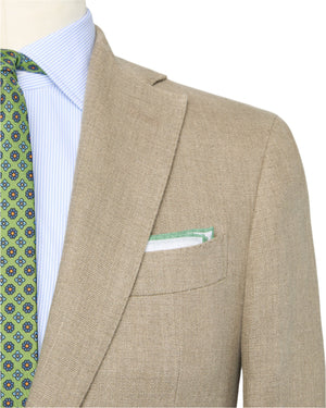 A close-up of the Sid Mashburn Kincaid No.2 Jacket in beige Italian hopsack, paired with a light blue shirt, green patterned tie, and a white pocket square trimmed in green.
