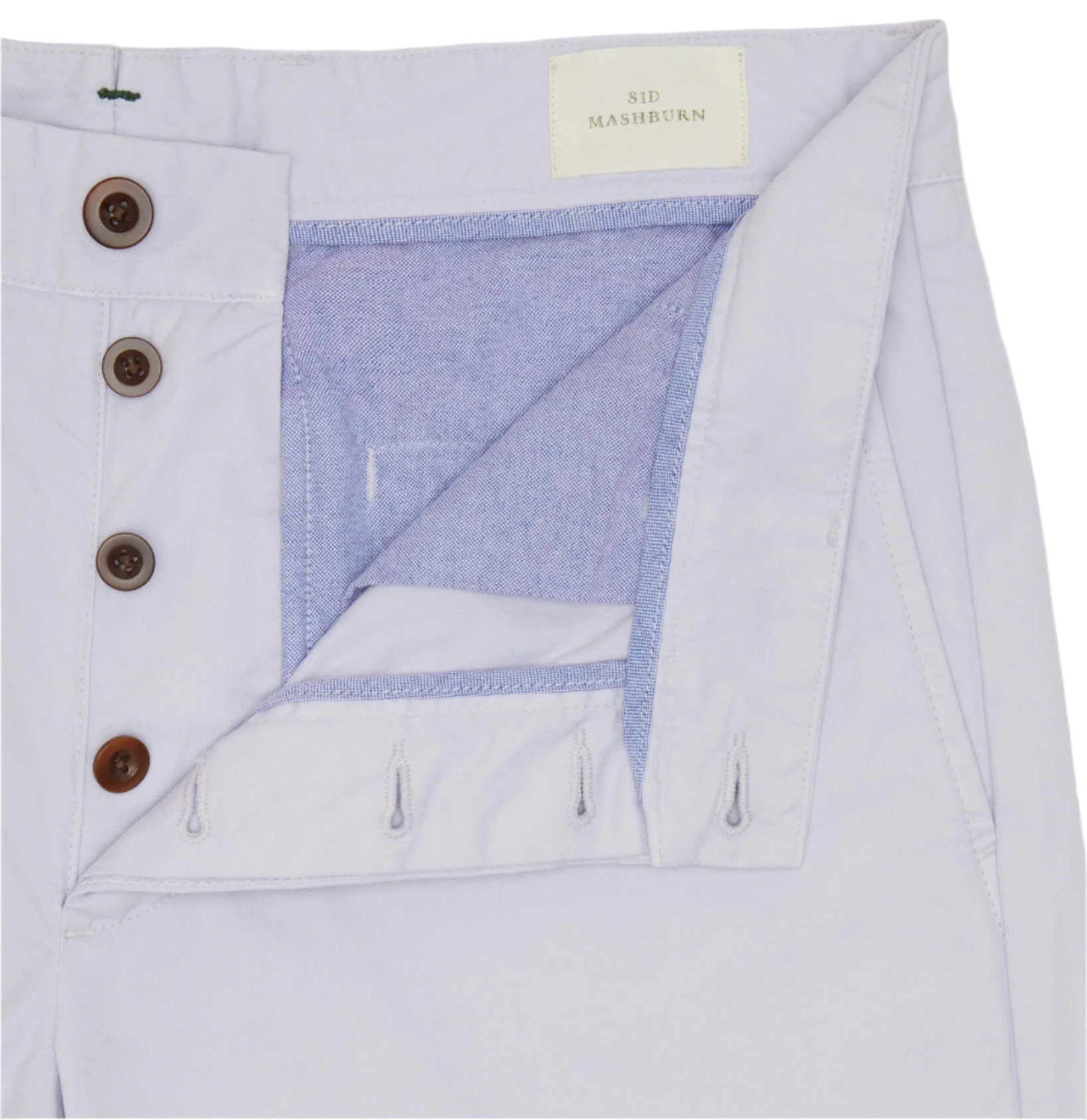 Close-up of Sid Mashburn Garment-Dyed Field Pant in light cotton twill, featuring a partially open button fly, visible interior stitching, and a "Sid Mashburn" label.