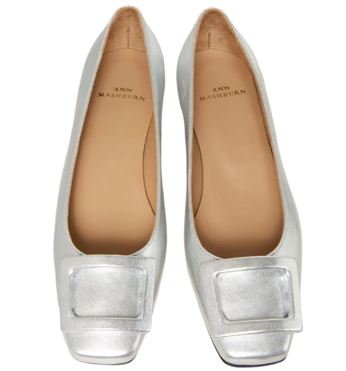 The Ann Mashburn Buckle Shoe is a pair of silver women's flats in metallic goat leather with square toes and front buckle accents, shown from above.