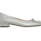 The Ann Mashburn Buckle Shoe for women is crafted in metallic silver goat leather with a demi heel, square toe, and a decorative rectangular front detail.