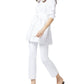 Someone wearing the Ann Mashburn Gabrielle Tie Tunic with white pants and black slip-on shoes walks against a plain background.