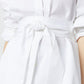 Close-up of a person wearing the Ann Mashburn Gabrielle Tie Tunic in white Italian poplin, featuring a wide fabric belt knotted at the waist.
