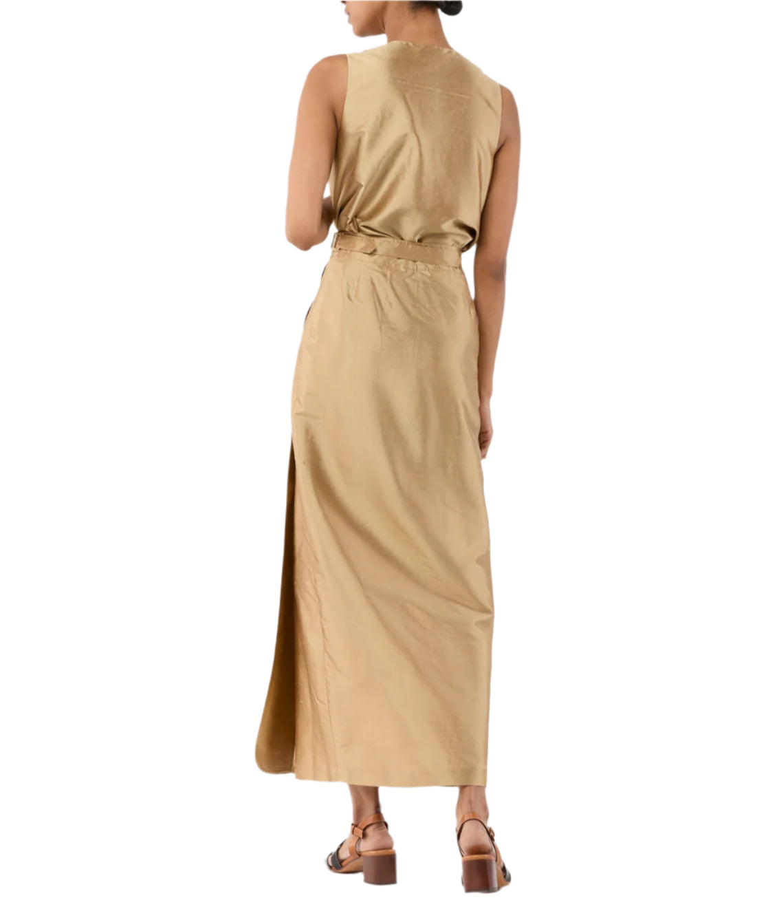 A person wearing a sleeveless tan maxi dress with a side slit, brown heeled sandals, and the Ann Mashburn Gia Silk Shantung Top, shown from the back.