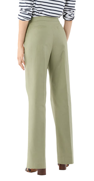 A person wearing the Ann Mashburn Hutton Stretch Canvas Pant in light green, brown heeled sandals, and a long-sleeve striped shirt is photographed from the back.
