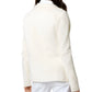 A person is dressed in a School Boy Jacket by Ann Mashburn, made from a luxurious cotton/silk blend, paired with white pants, viewed from the back.