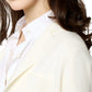 Someone in an Ann Mashburn School Boy Jacket over a cotton/silk blend button-up shirt, with long brown hair cascading elegantly.