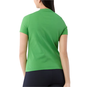 A person with long dark hair, seen from behind, wears the Ann Mashburn Lee Tee in green and black pants against a white background.