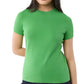 A person wears the Ann Mashburn Lee Tee, a plain green luxury t-shirt with a body-hugging fit, paired with dark pants and standing against a white background.