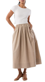 A person wearing the Cosette Cotton Silk Dress by Ann Mashburn with brown heeled sandals.