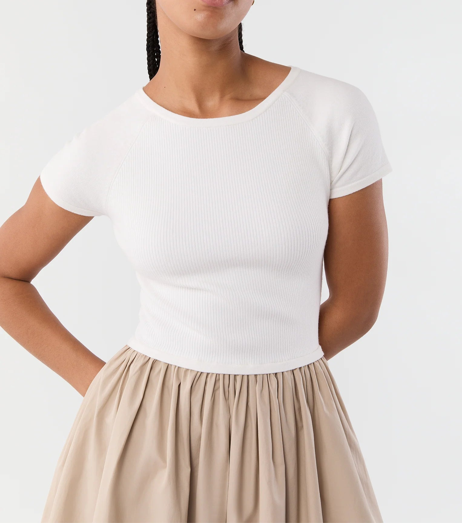 A person wearing the Cosette Cotton Silk Dress by Ann Mashburn, standing with hands behind their back against a plain background.