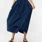 Model wearing the Ann Mashburn Cosette Cotton Silk Dress, holding the sides to showcase its fullness against a plain background.