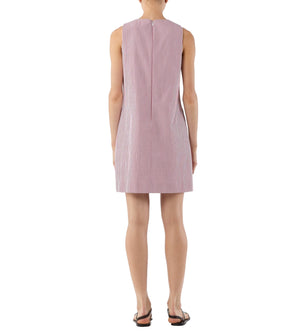A person stands facing away, wearing the Ann Mashburn Susy Shift Dress—a sleeveless, knee-length, red and white vertically striped 1960s A-line dress in Japanese compact cotton—with black sandals.