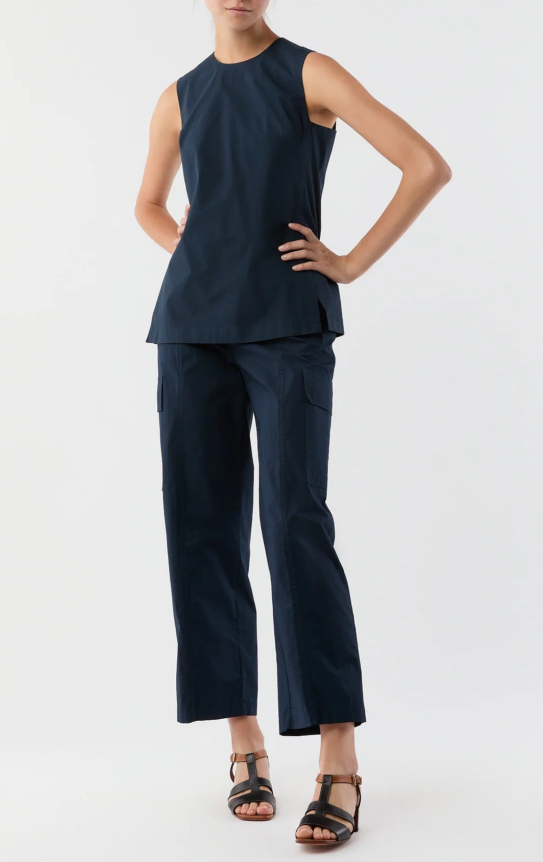 A model wears the Ann Mashburn Jo Bi-Stretch Tropical Wool Tunic in navy with matching straight-leg cargo pants and black heeled sandals, set against a plain white background.
