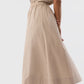 Miranda wears the Ann Mashburn Miranda Poplin Skirt, a beige Italian poplin midi skirt with an elastic waist, styled with a matching short-sleeve button-up shirt and leopard print block-heel shoes.