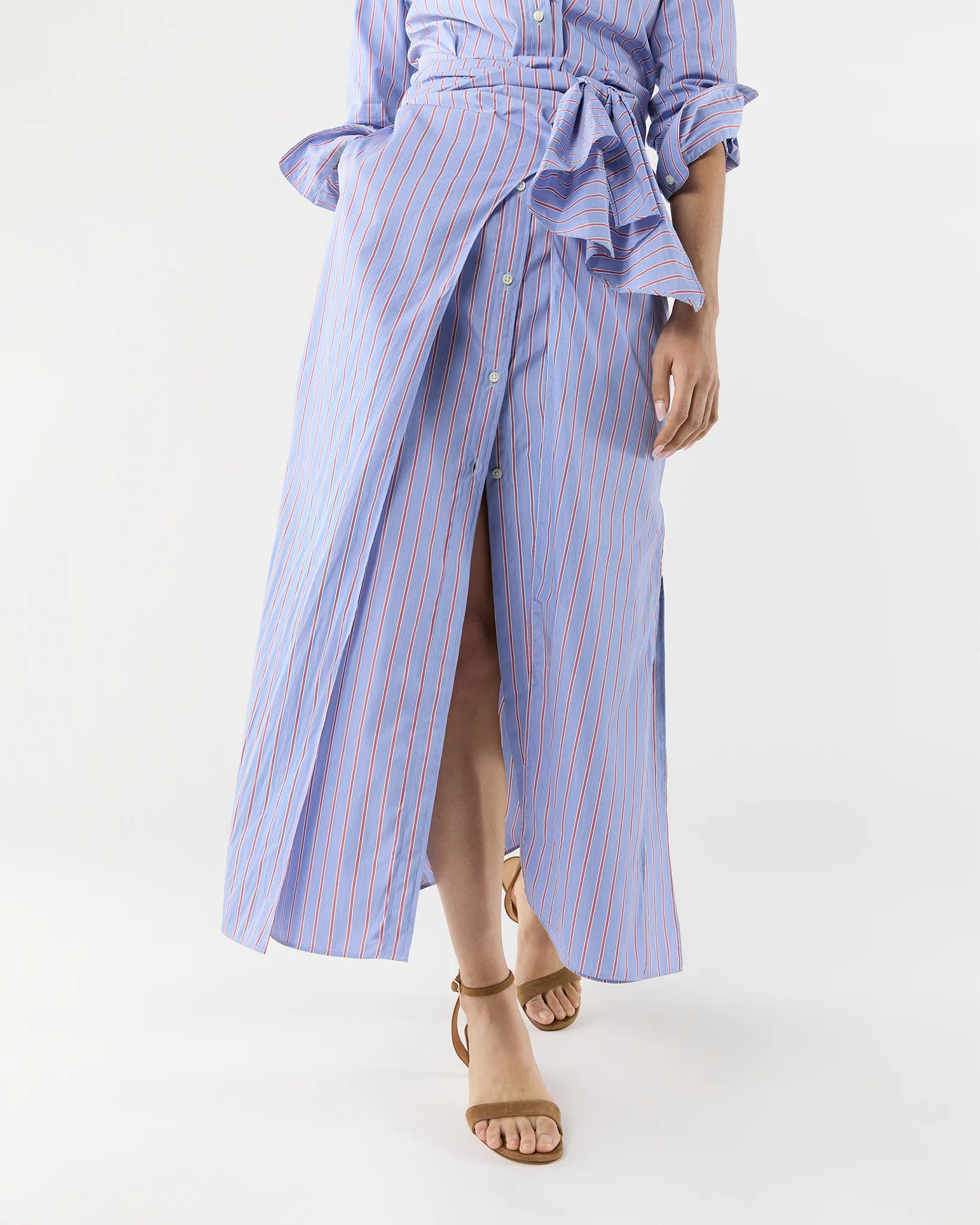 A person wearing the Ann Mashburn Maxi Tie-Waist Shirtdress paired with a matching blouse and brown sandals.