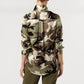 Back view of a person wearing an Ann Mashburn Classic Silk Charmeuse Blouse featuring a camouflage print, long sleeves, and a collared neckline.