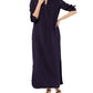 A woman wears the Ann Mashburn Piper Maxi Dress, a long-sleeve, collared, ankle-length crepe de chine dress with a front slit, styled with black sandals.