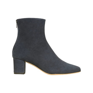 The Ann Mashburn Zip-Back Boot is a dark blue lamb suede ankle boot featuring a block heel, side zipper, and almond toe, made in Italy and shown on a white background.