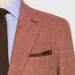 Close-up of a person wearing the Sid Mashburn Kincaid No. 3 Jacket, paired with a light blue striped shirt, brown knitted tie, and a patterned pocket square.