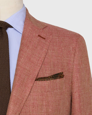 Close-up of a person wearing the Sid Mashburn Kincaid No. 3 Jacket, paired with a light blue striped shirt, brown knitted tie, and a patterned pocket square.