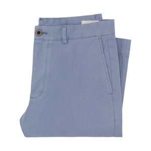 The Sid Mashburn Garment Dyed Field Pant, in light blue cotton twill, is neatly folded and features a front button closure with side pockets.