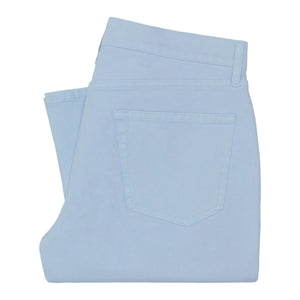 A pair of Sid Mashburn Clift Straight Leg Jeans in light blue, garment-dyed and neatly folded with the back pocket visible, isolated on a white background.