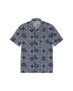 The Sid Mashburn Ripley Shirt, a short-sleeve button-up featuring a navy and white geometric pattern inspired by 1950s vacation styles, is laid flat on a white background.