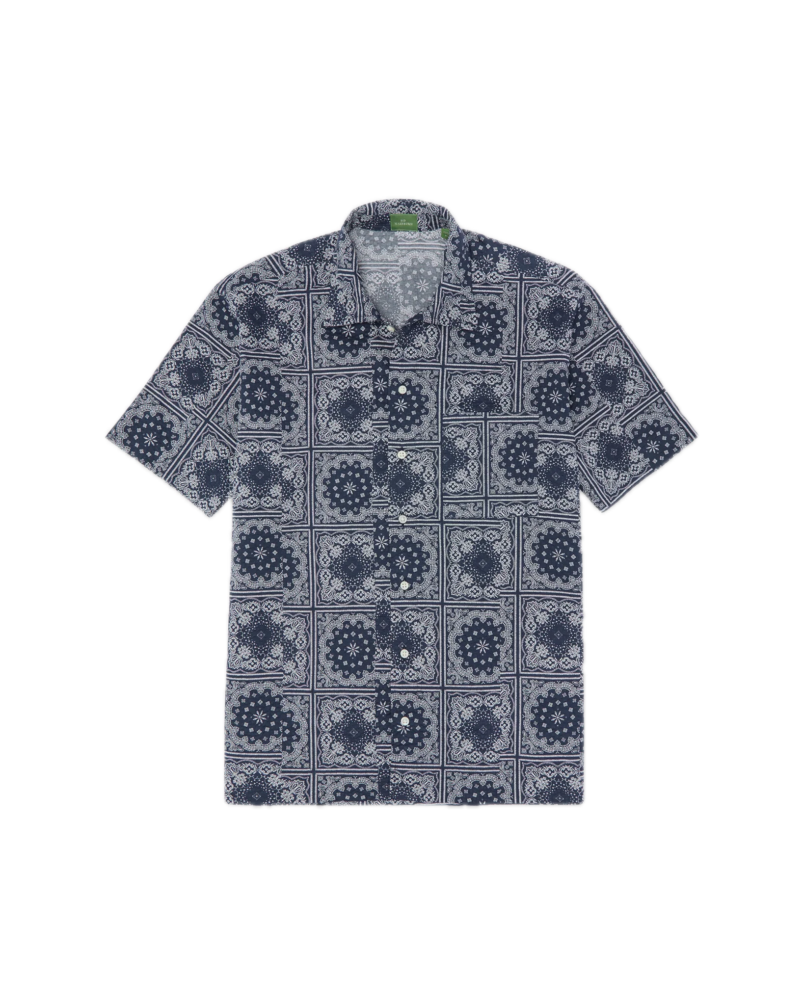 The Sid Mashburn Ripley Shirt, a short-sleeve button-up featuring a navy and white geometric pattern inspired by 1950s vacation styles, is laid flat on a white background.