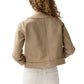 A person with curly hair, seen from behind, wears the Ann Mashburn Kiki Stretch Canvas Jacket and white pants against a plain white background.