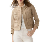 A woman wears the Ann Mashburn Kiki Stretch Canvas Jacket, a tan cotton canvas layering piece with four front pockets, styled over a white top and white pants.