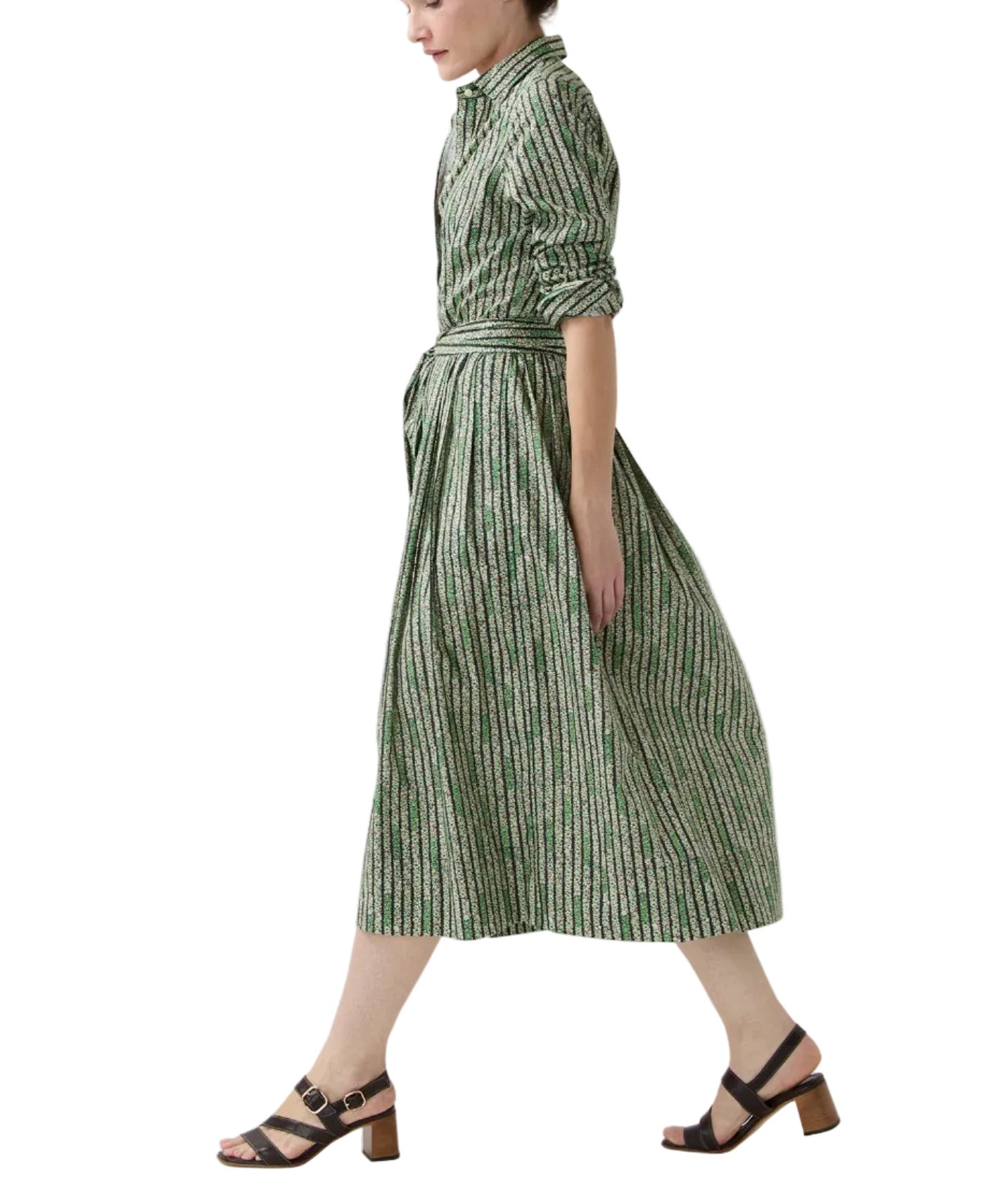 A person wears the Ann Mashburn Classic Shirtwaist Floral Stripe Dress with a matching belt and black heeled sandals, walking against a white background.