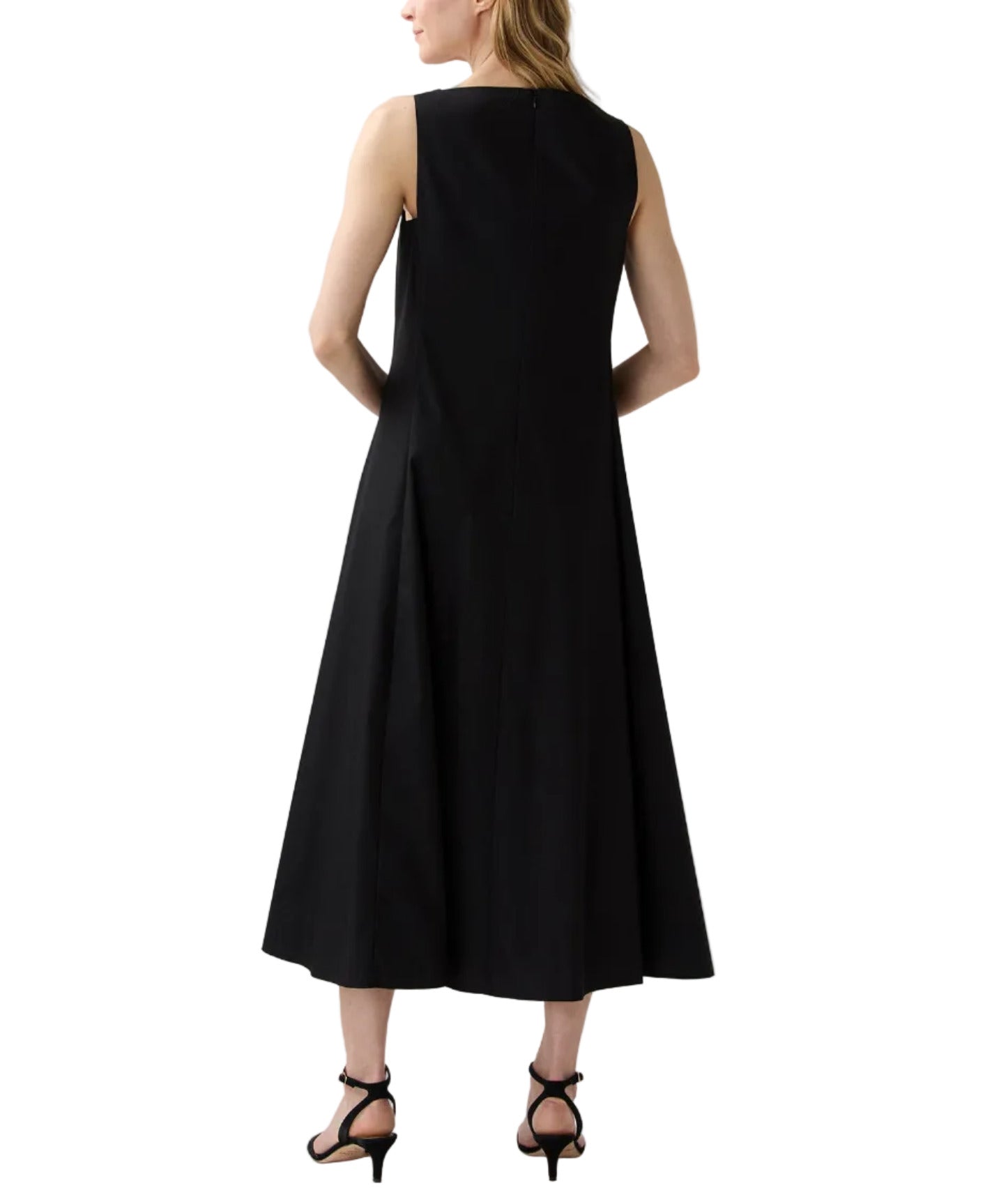 A woman is shown from the back against a white background, wearing Ann Mashburn's Rosalind Dress—a sleeveless, ankle-length black poplin dress—and black heeled sandals.