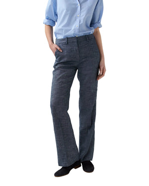 Person wears a light blue Italian chambray button-up with sleeves rolled up, paired with Ann Mashburn's Lane Cotolino Chambray Pant, standing with one hand in a pocket.