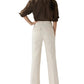 A woman faces away, wearing a brown long-sleeve shirt with rolled sleeves and cream Camille Patch-Pocket Stretch Jeans by Ann Mashburn.