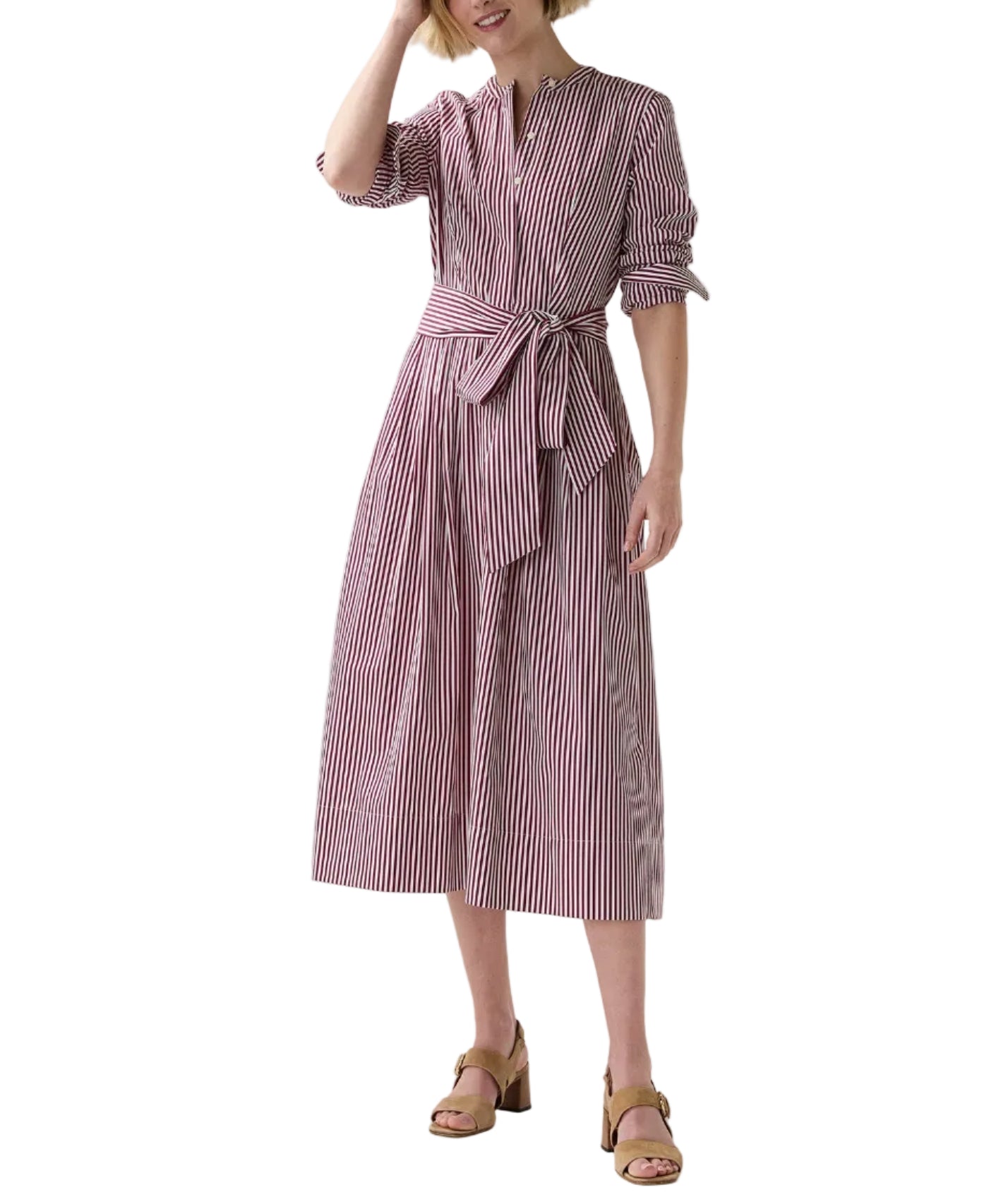 A woman wears the Ann Mashburn Felicity Shirtwaist Dress—red and white bengal-striped poplin with a waist tie—paired with tan heeled sandals.