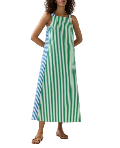 A woman wears the Ann Mashburn Lise Maxi Dress—an ankle-length, sleeveless A-line in blue and green striped Italian poplin—paired with brown flat sandals.