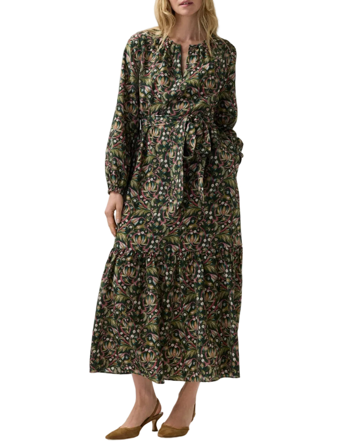 Aba Silk Maxi Dress in a dark floral print with a tiered skirt, tie waist, and elasticated cuffs, styled with brown slingback heels for a flattering party silhouette.