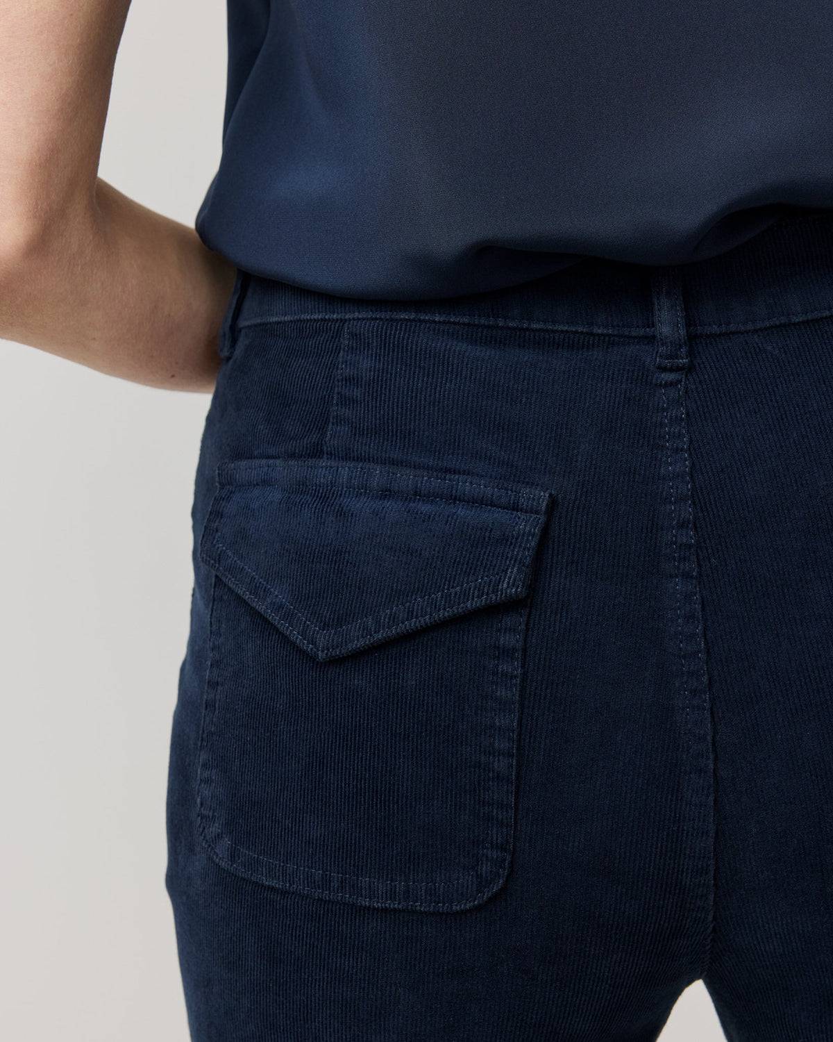 Ann Mashburn Camille Patch-Pocket Stretch Corduroy Jean in dark blue, featuring a straight leg fit and a rear patch pocket with a flap.