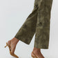 An individual stands against a white background wearing the Ann Mashburn Frankie Stretch Twill Cropped Pant, featuring a barely-there waistband, paired with brown slingback kitten heels.