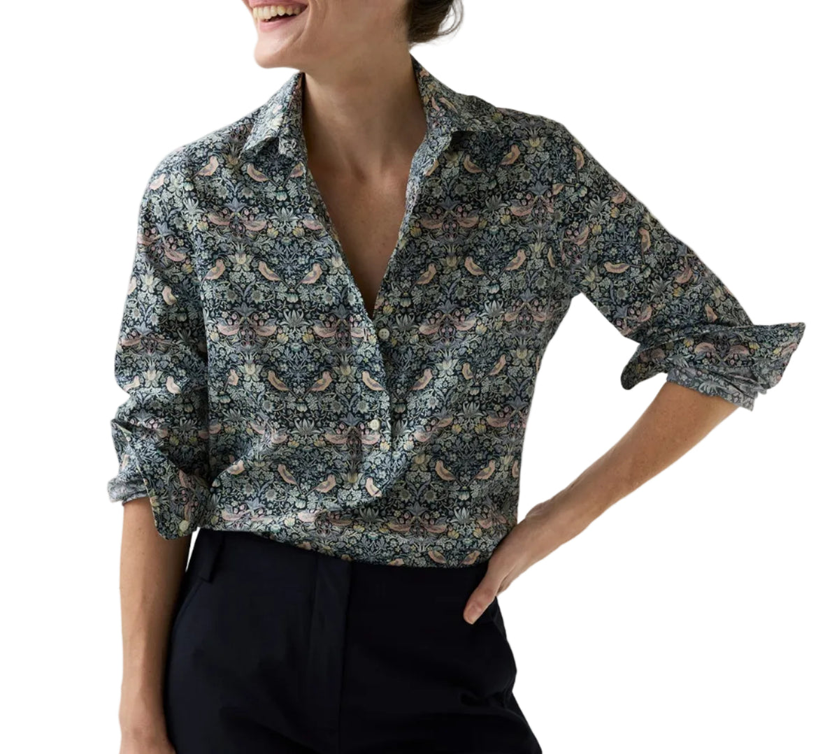 A woman wearing an Ann Mashburn Tomboy Popover Liberty Shirt in a dark floral and bird print.