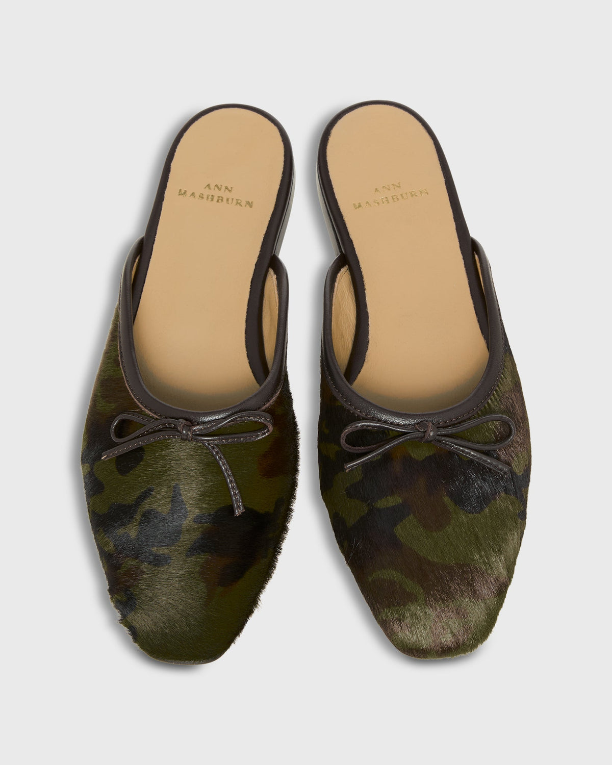Ann Mashburn Joy Mule camouflage-print slip-on flat mules with an almond-shaped toe and a small bow detail.